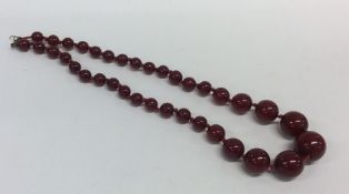 A graduated string of red amber beads with conceal