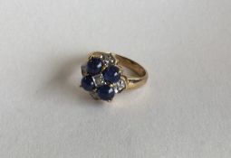 A cabochon sapphire and diamond cluster ring in 9