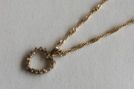 A small diamond heart shaped pendant with loop top