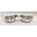 A pair of Edwardian silver sauce boats with card c
