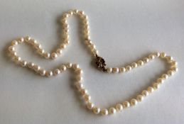 A string of pearls with 9 carat clasp inset with g