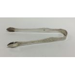 A pair of Georgian silver bright cut sugar tongs.