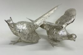 An exquisite pair of cast silver pheasants with te