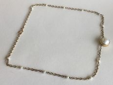 A 9 carat pearl chain with ring clasp. Approx. 8.6