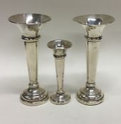 A pair of tapering silver spill vases together wit