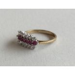 A ruby and diamond triple row ring in 9 carat sett