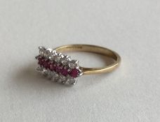 A ruby and diamond triple row ring in 9 carat sett