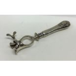An unusual Continental silver meat clamp with engi