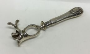 An unusual Continental silver meat clamp with engi
