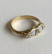 An opal and diamond six stone ring in 18 carat gol