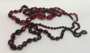 Two large strings of faceted amber beads. Approx.