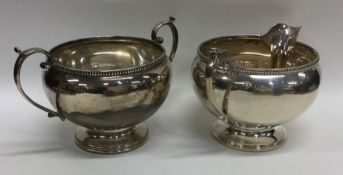 An Edwardian silver cream jug together with matchi