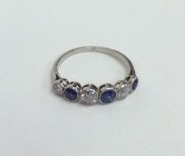A sapphire and diamond six stone ring in rubover m