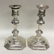A pair of Georgian style silver candlesticks with
