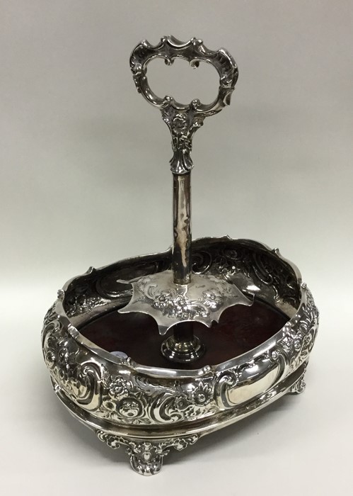 A Victorian embossed silver cruet stand decorated