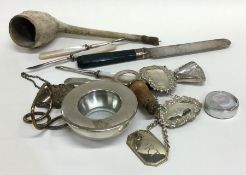 A bag containing silver wine labels, caddy scoops