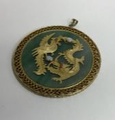 A circular gold mounted pendant inset with opals o