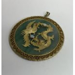 A circular gold mounted pendant inset with opals o