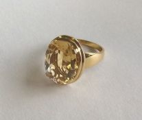 A high carat gold mounted single stone ring in cla