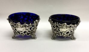 A pair of Victorian silver salts decorated with sc