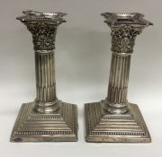 A pair of Corinthian column dwarf candlesticks on