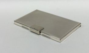 A heavy silver engine turned card case with hinged
