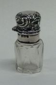 A miniature hinged top silver scent bottle and sto