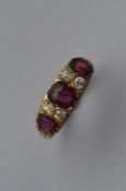 A good ruby and diamond seven stone half hoop ring