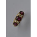 A good ruby and diamond seven stone half hoop ring