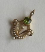 A 15 carat pearl and peridot pendant with loop top