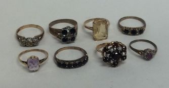 A bag containing eight 9 carat gem set rings. Appr