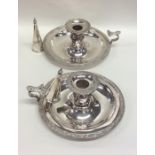 A pair of silver plated chamber sticks and extingu