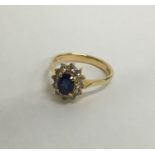 An 18 carat sapphire and diamond oval cluster ring