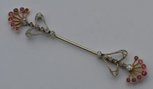 An attractive French diamond and ruby scarf pin in