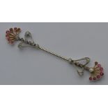 An attractive French diamond and ruby scarf pin in