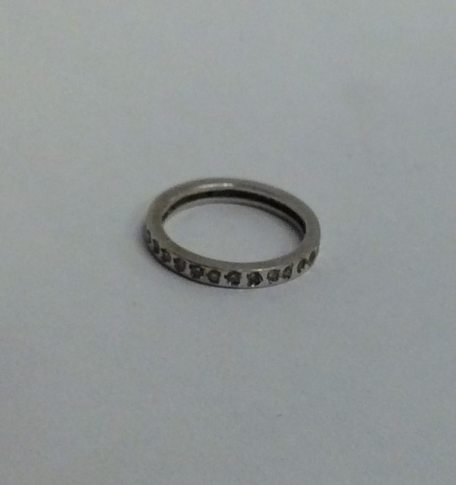 A white gold and diamond full eternity ring. Ring