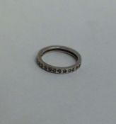 A white gold and diamond full eternity ring. Ring