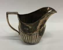 A silver half fluted cream jug. Sheffield. By JH.