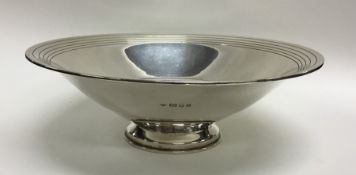 A heavy tapering silver fruit bowl with engine tur