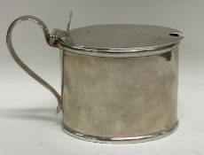 A good Georgian oval silver mustard pot. London. B