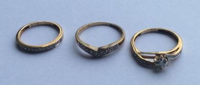 A group of three 9 carat diamond set rings. Approx
