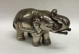 A heavy silver model of an elephant with textured