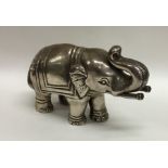 A heavy silver model of an elephant with textured