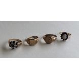 A group of four 9 carat gem set rings. Approx. 11.