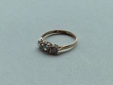 A small diamond three stone ring in 9 carat claw m
