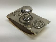 A Russian silver desk blotter decorated with coins