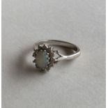 An opal and diamond daisy head cluster ring in 18