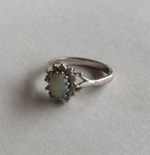An opal and diamond daisy head cluster ring in 18