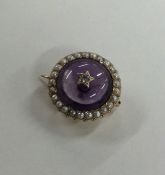 A Victorian amethyst and pearl brooch in gold fram