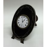 A stylish silver and tortoiseshell clock with whit